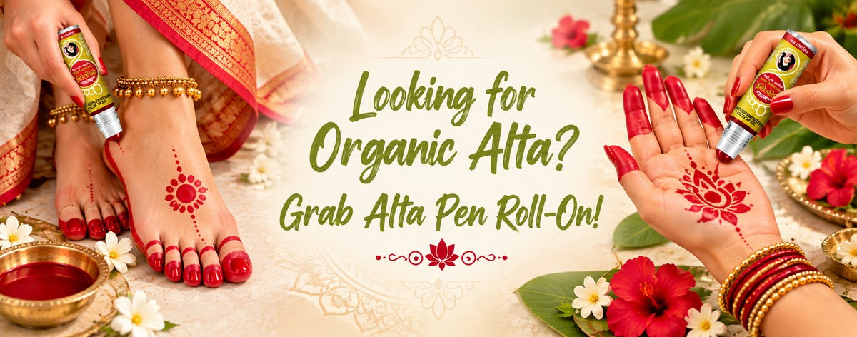 Banner featuring Keya Seth Aromatherapy Alta Roll-On Pen with traditional red alta designs on a woman’s hands and feet, surrounded by hibiscus, jasmine, green leaves, and festive Bengali elements.