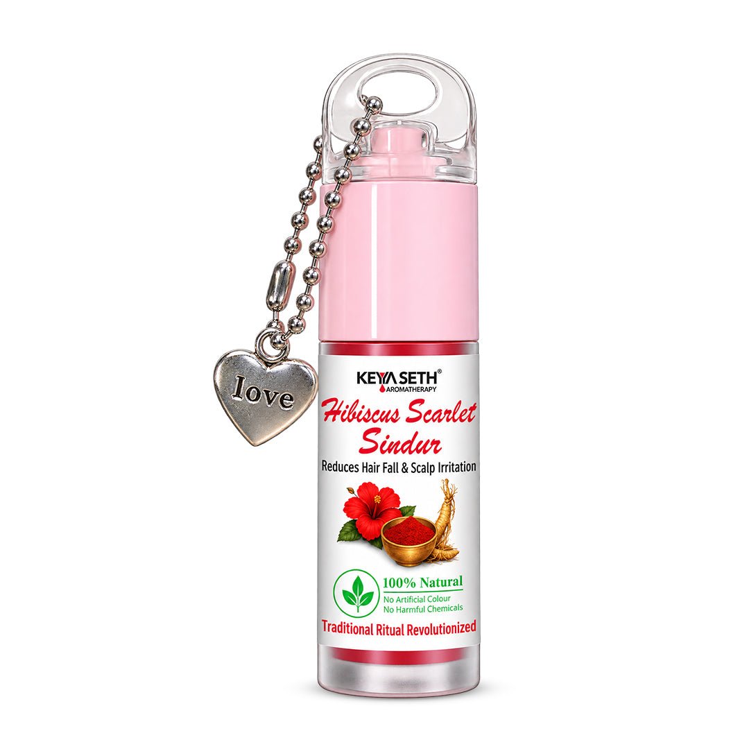 Hibiscus Scarlet Red Liquid Sindoor bottle with pink cap and heart charm, front view.
